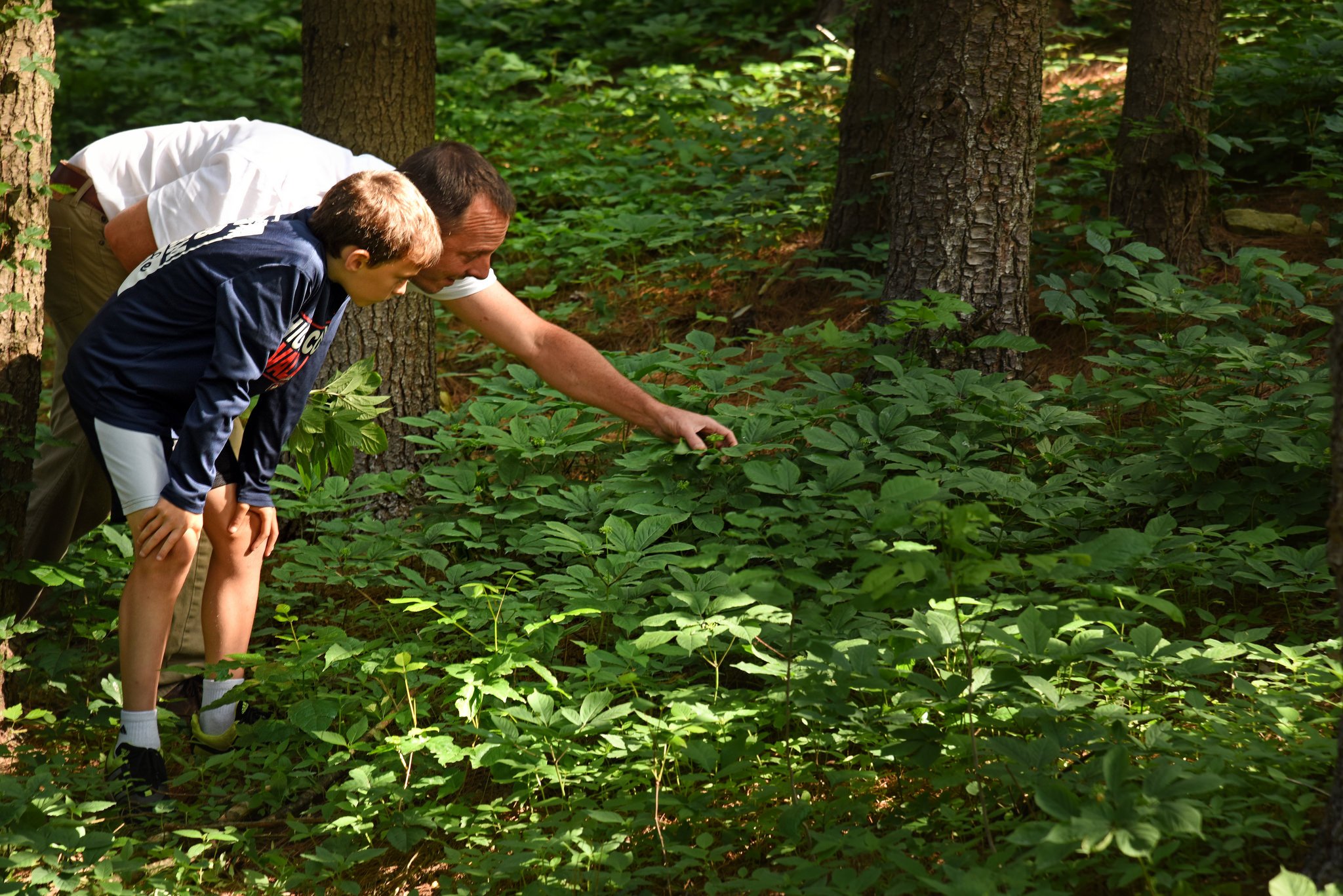 Adult Volunteer helping youth in nature