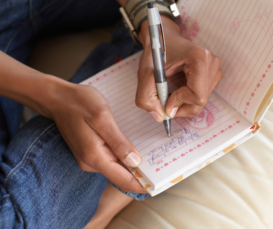 close-up of hand journaling